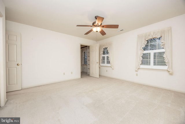 empty room featuring baseboards, a ceiling fan, visible vents, and carpet flooring