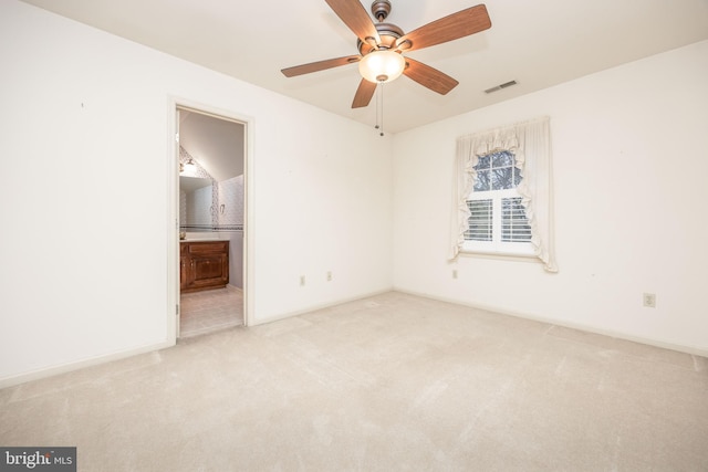 unfurnished bedroom featuring baseboards, ensuite bathroom, visible vents, and carpet floors