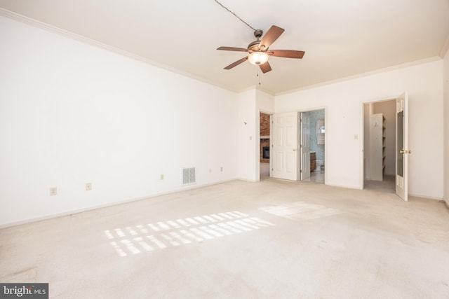 unfurnished bedroom with baseboards, visible vents, carpet, and crown molding