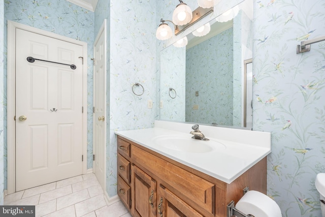 bathroom with wallpapered walls, tile patterned flooring, vanity, and toilet