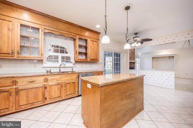 kitchen with a sink, wallpapered walls, a ceiling fan, dishwasher, and a kitchen island