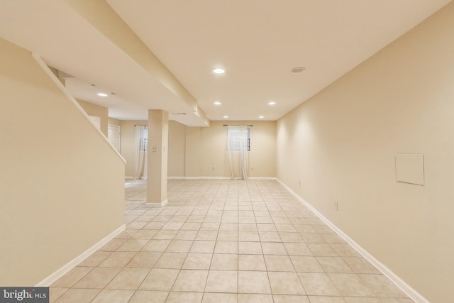 basement with recessed lighting, baseboards, and light tile patterned floors