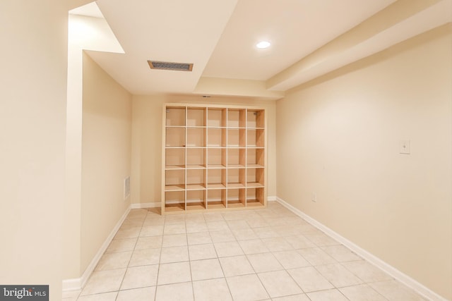 empty room featuring light tile patterned floors, baseboards, recessed lighting, and visible vents