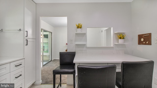 dining room featuring light wood-style floors and baseboards