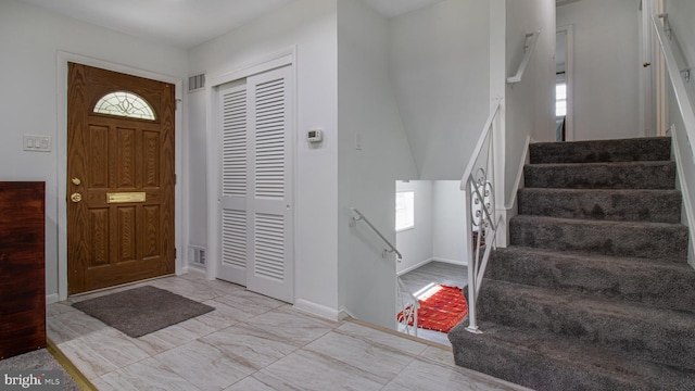 foyer with visible vents, marble finish floor, and a wealth of natural light