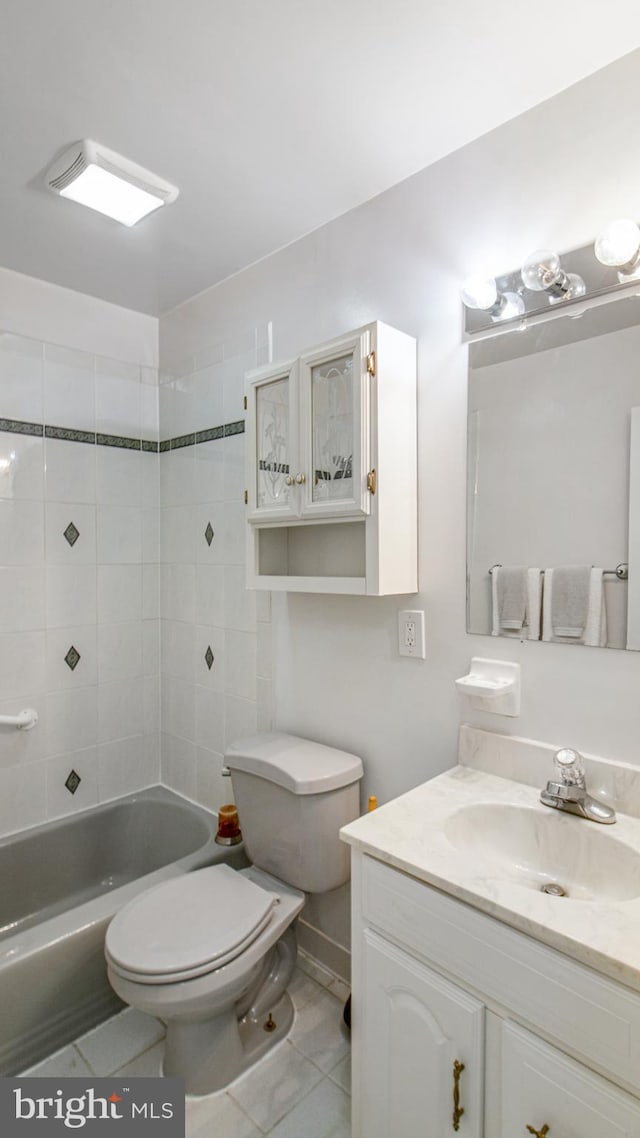 bathroom with vanity, tile patterned flooring, shower / bathing tub combination, and toilet
