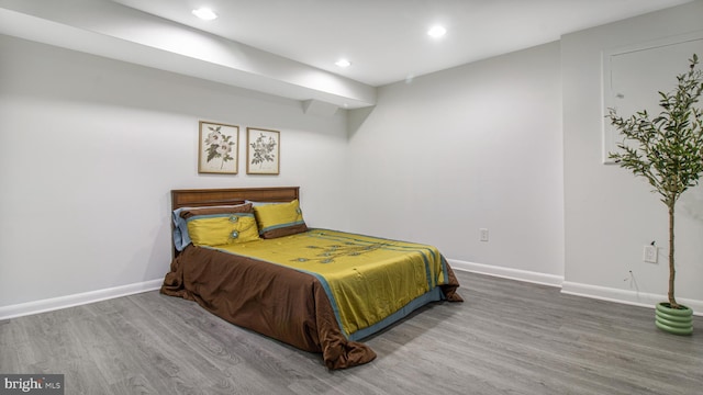 bedroom featuring baseboards, recessed lighting, and wood finished floors