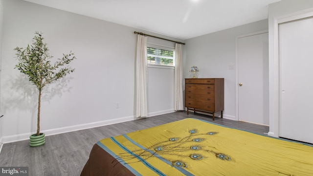 bedroom with baseboards and wood finished floors