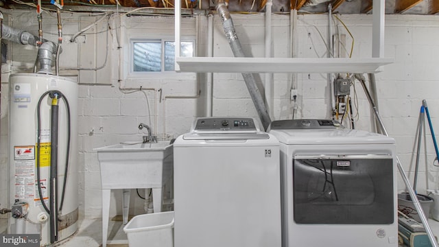washroom with separate washer and dryer, laundry area, and gas water heater