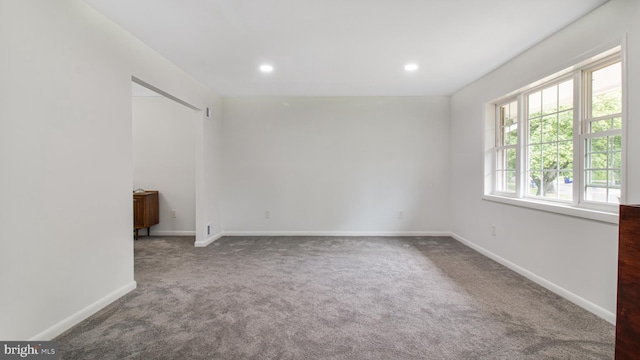 spare room with baseboards, carpet, and recessed lighting