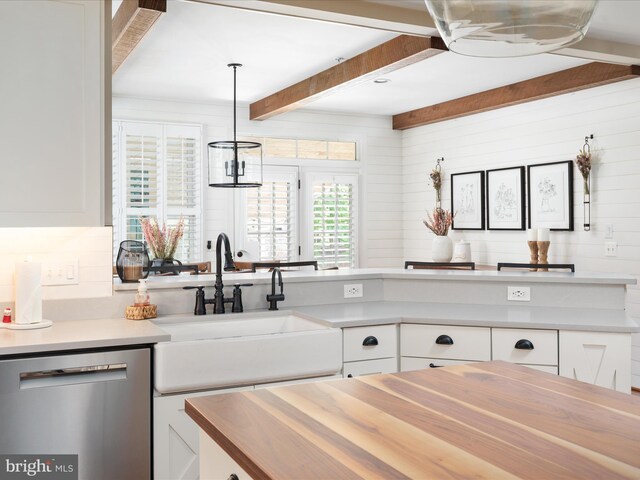 kitchen featuring a sink, white cabinetry, dishwasher, and beam ceiling