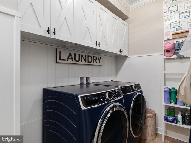 washroom featuring ornamental molding, cabinet space, washing machine and dryer, and wainscoting