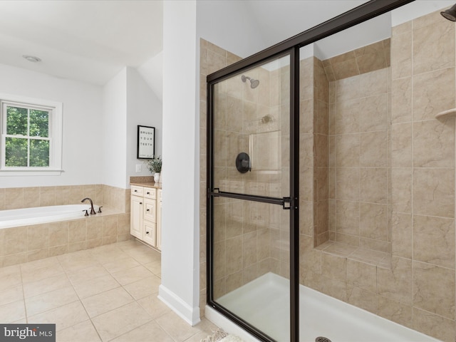 bathroom featuring tile patterned flooring, a garden tub, a stall shower, and vanity