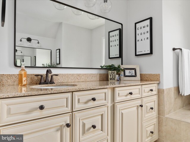 bathroom featuring vanity and vaulted ceiling