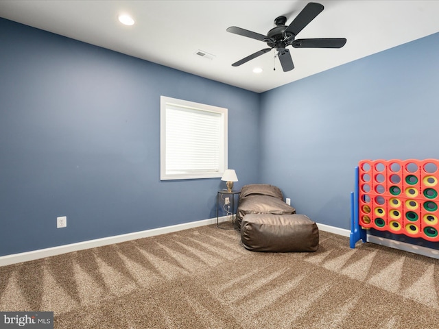 unfurnished room with baseboards, ceiling fan, carpet, and visible vents