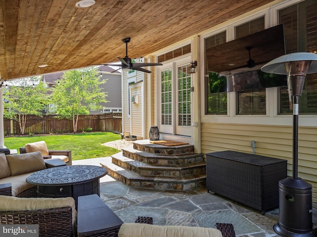 view of patio / terrace featuring a fenced backyard, ceiling fan, an outdoor hangout area, and entry steps