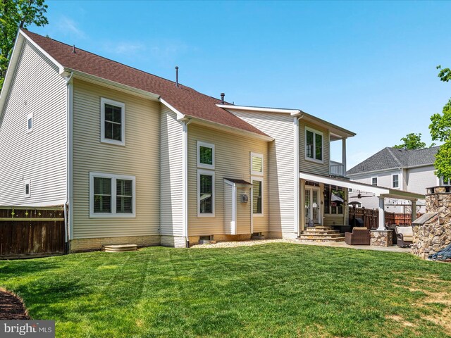 back of property featuring fence, a patio, and a yard
