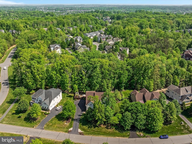 aerial view featuring a residential view and a wooded view