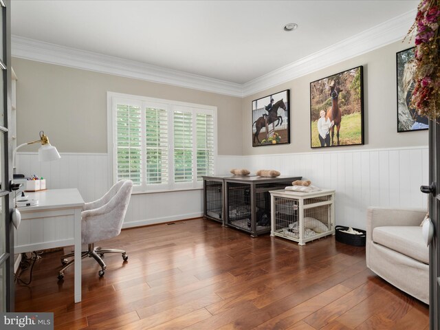 office featuring crown molding, visible vents, wood finished floors, and a wainscoted wall