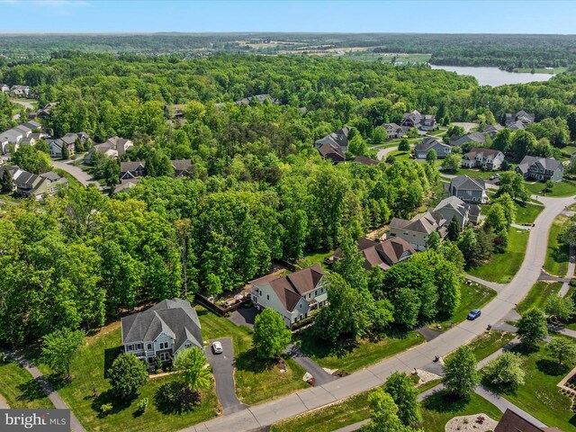 birds eye view of property with a view of trees and a residential view