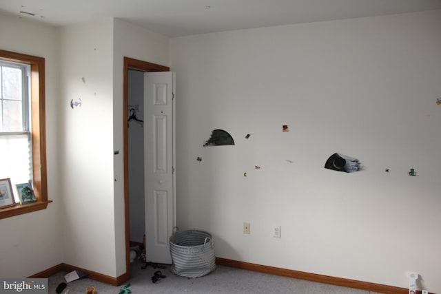 interior space featuring carpet and baseboards