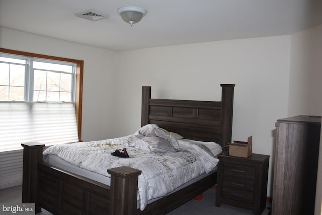 bedroom with visible vents and carpet flooring