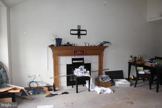 carpeted office space with a fireplace