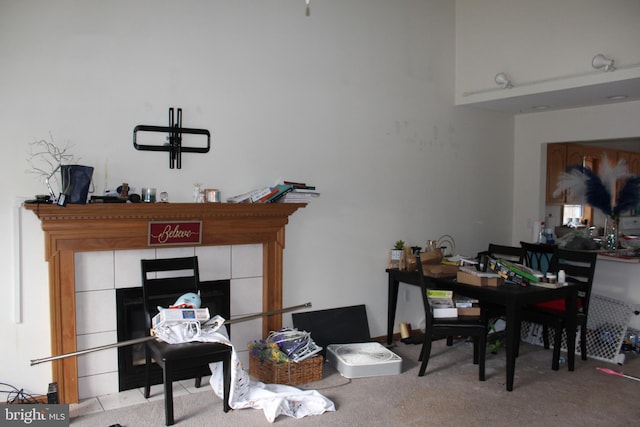 carpeted home office featuring a fireplace