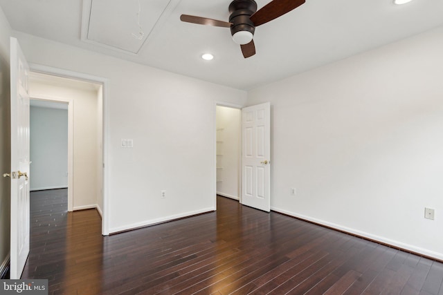 spare room featuring recessed lighting, a ceiling fan, baseboards, attic access, and hardwood / wood-style flooring