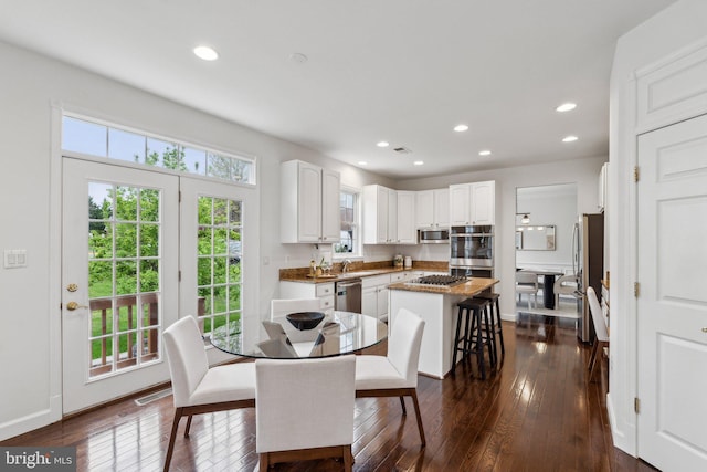 dining space with baseboards, recessed lighting, and dark wood-style flooring