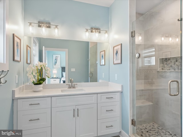 ensuite bathroom featuring vanity, a stall shower, and ensuite bathroom