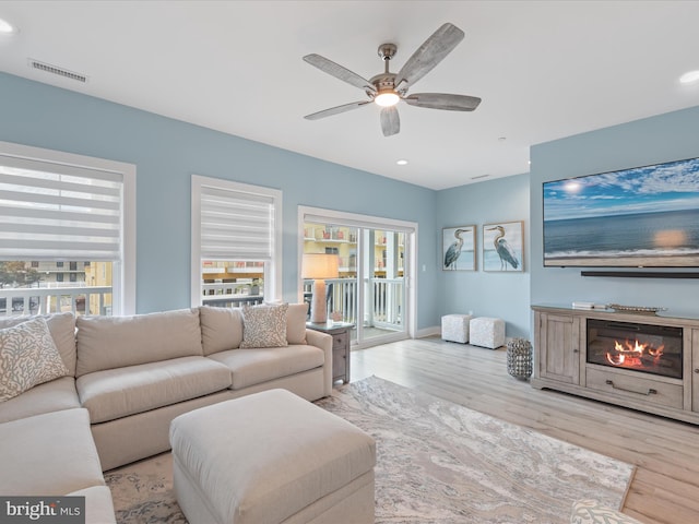 living room with visible vents, a ceiling fan, wood finished floors, and recessed lighting