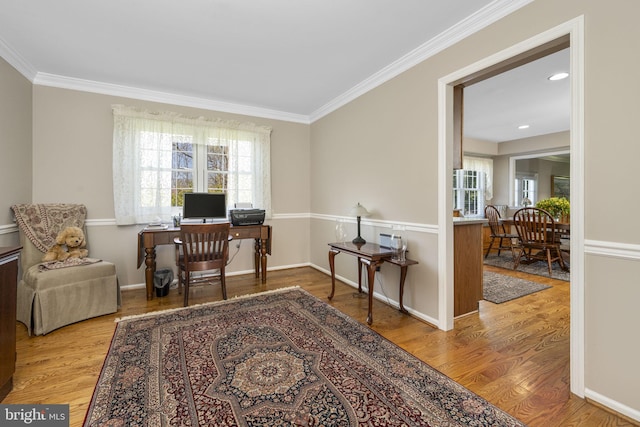 office space featuring baseboards, wood finished floors, and crown molding
