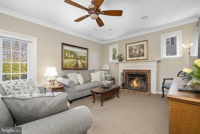 living area with baseboards, carpet, a ceiling fan, crown molding, and a fireplace