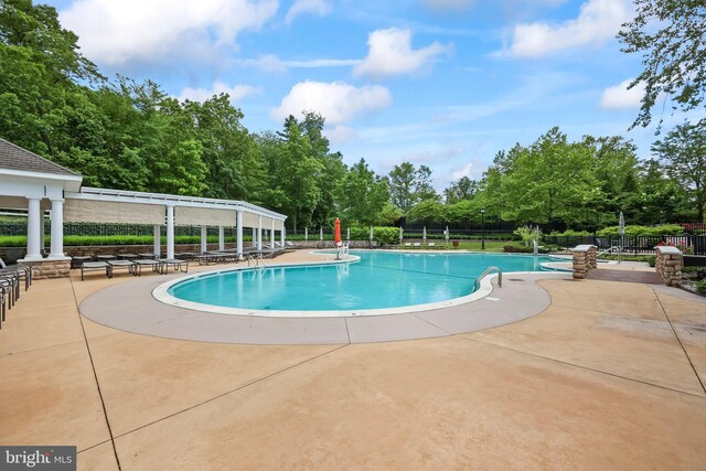 12 Citation Ln, Manalapan, NJ 07726 - community pool with a patio area and view of wooded area