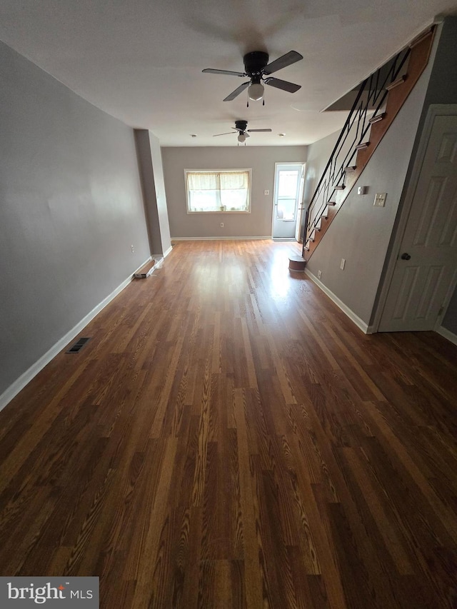 3117 Edgemont St, Philadelphia, PA 19134 - unfurnished living room with dark wood-style flooring, baseboards, visible vents, a ceiling fan, and stairs
