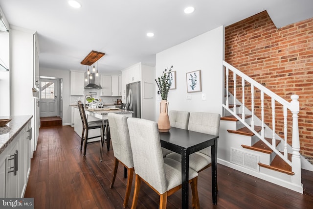 dining area with stairs, baseboards, dark wood-style flooring, visible vents, and recessed lighting