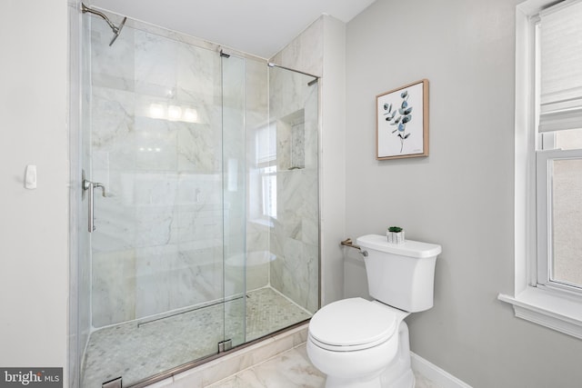 bathroom featuring a shower stall, baseboards, marble finish floor, and toilet