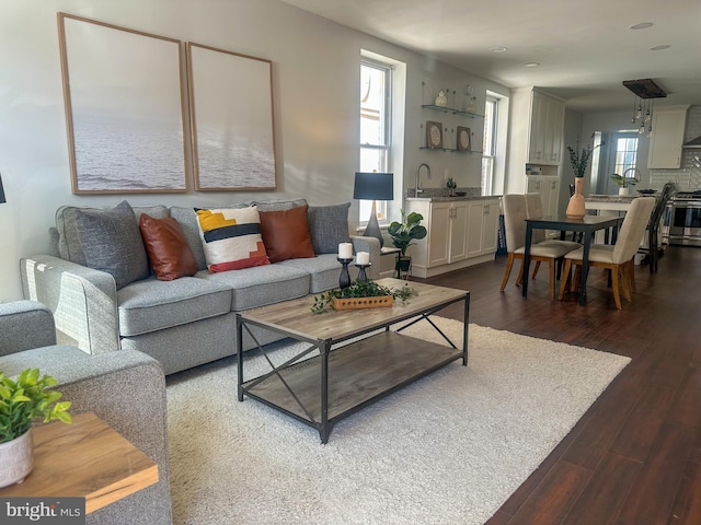 living room with dark wood finished floors and recessed lighting