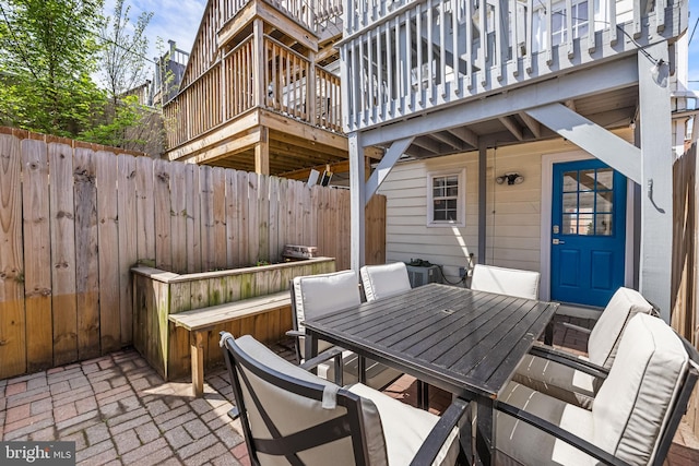 view of patio / terrace featuring a fenced backyard, outdoor dining area, and a deck