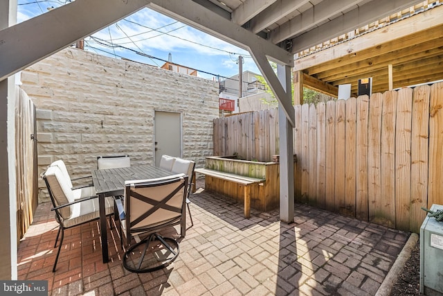 view of patio / terrace featuring fence and outdoor dining space