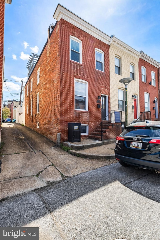 view of property featuring brick siding