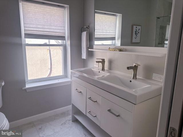 full bathroom with a sink, marble finish floor, double vanity, baseboards, and toilet