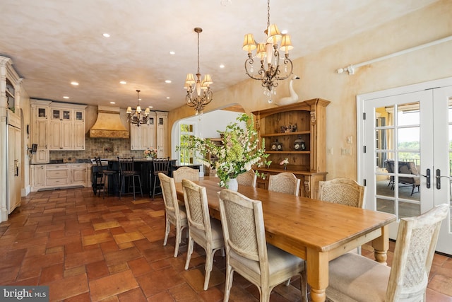 dining space featuring a wealth of natural light, french doors, a chandelier, and recessed lighting