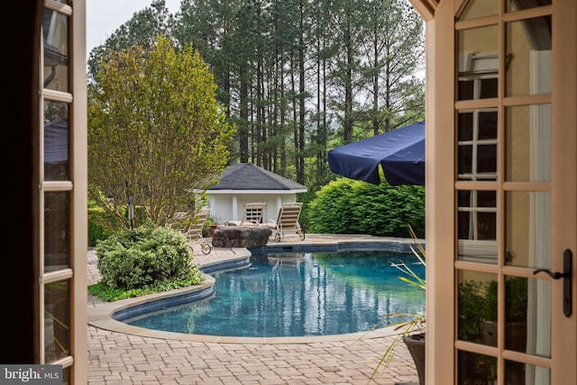 outdoor pool with a patio area