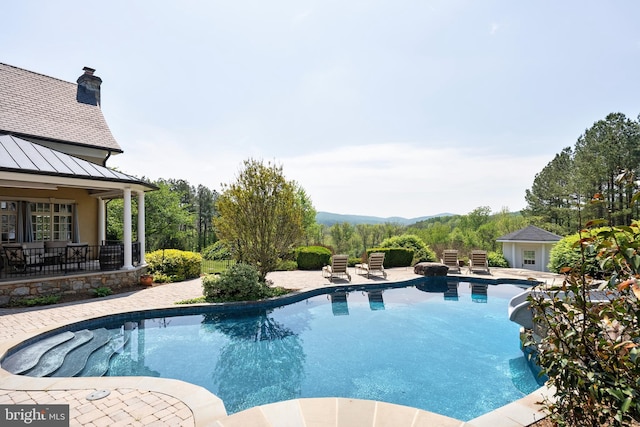 outdoor pool with a patio area