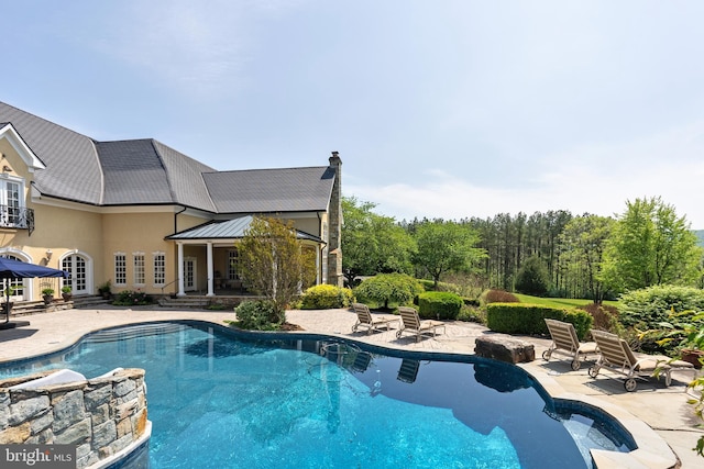 outdoor pool featuring a patio area