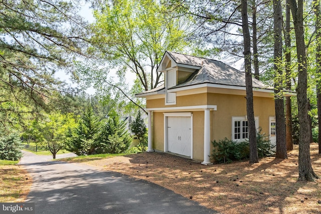 view of outdoor structure with a garage and driveway