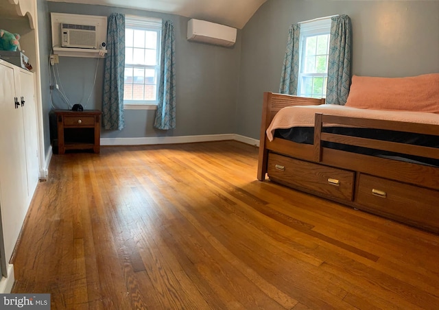 2619 Filbert Ave, Reading, PA 19606 - bedroom featuring wood-type flooring, an AC wall unit, multiple windows, a wall mounted AC, and lofted ceiling