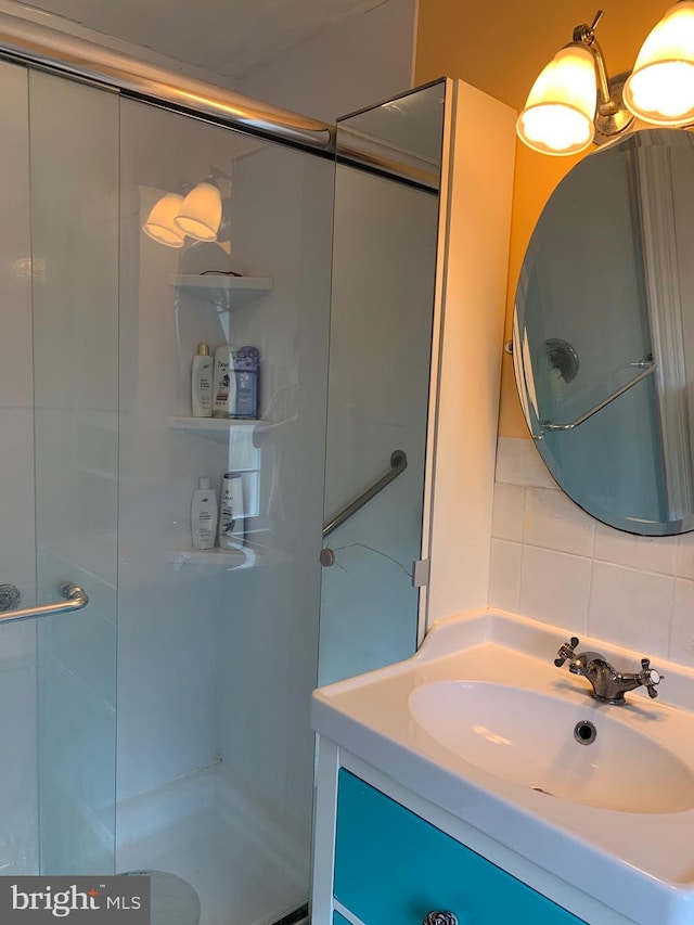 2619 Filbert Ave, Reading, PA 19606 - bathroom featuring a shower stall, vanity, and tasteful backsplash